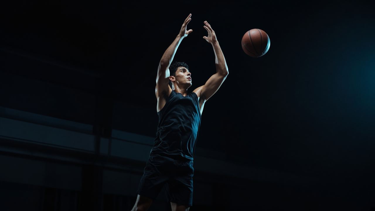 Basketball athlete exploding into a jump on court