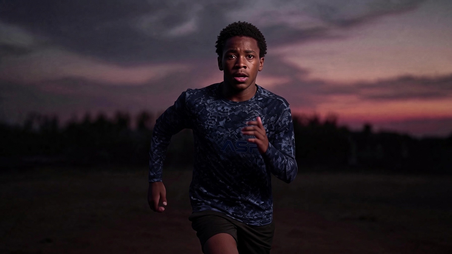 Young athlete driving out of the first steps at dusk