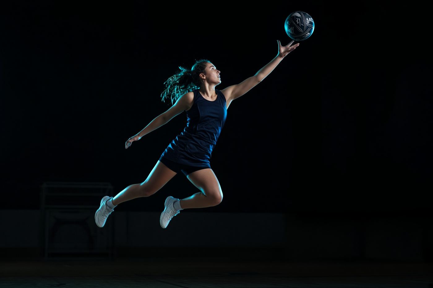 Netball athlete landing after a contested jump